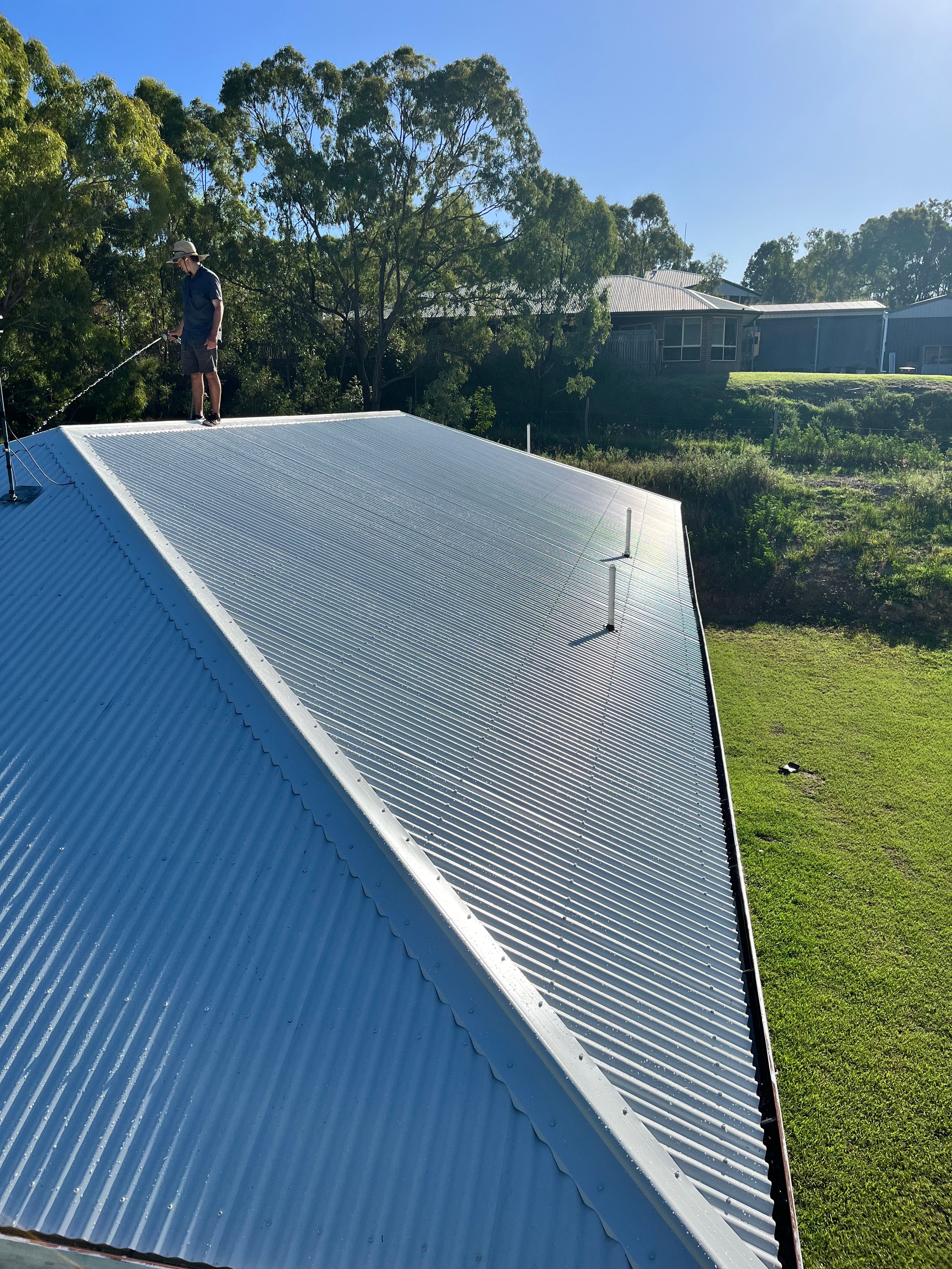 Worker on completed flat metal roof