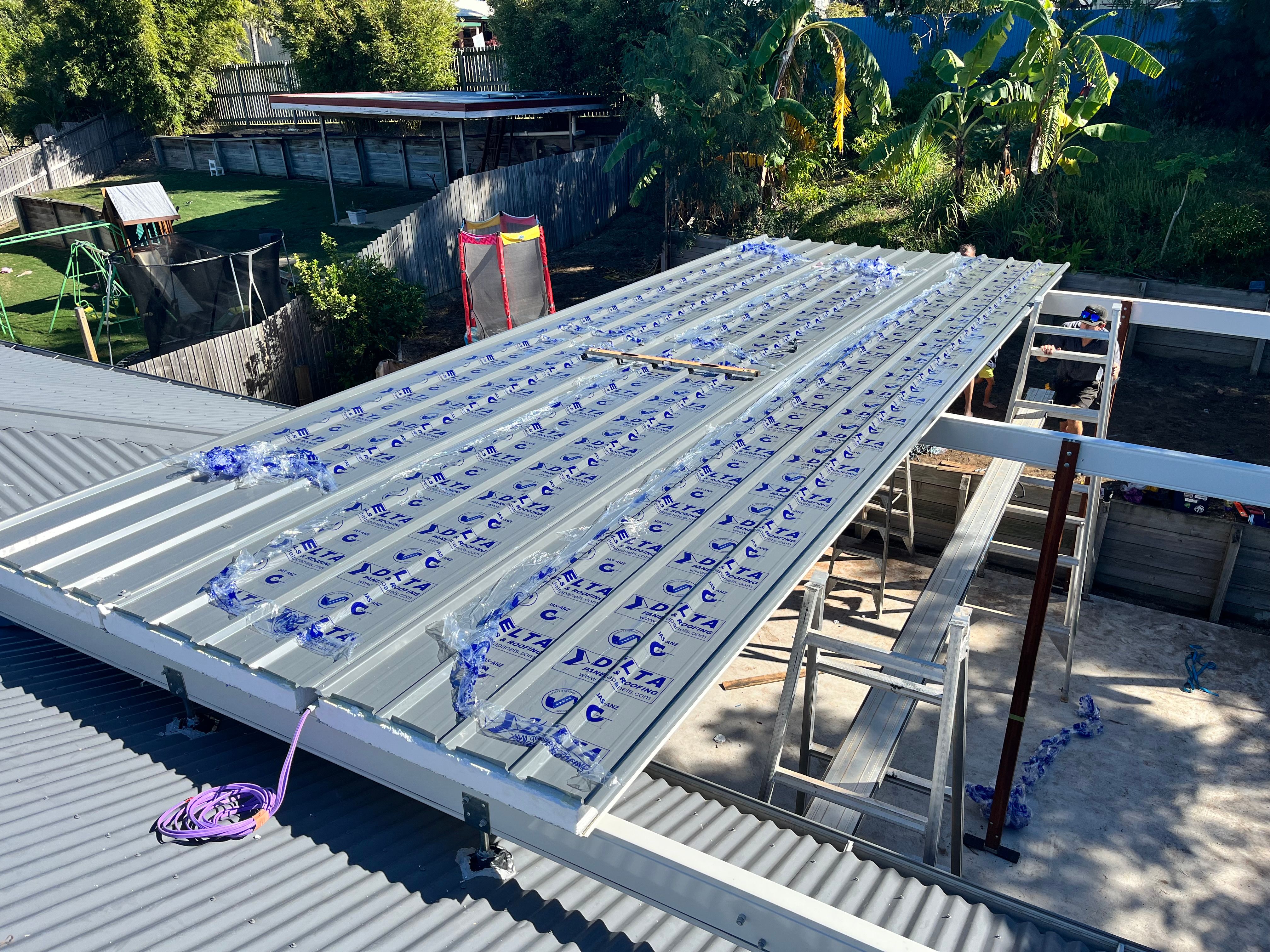 New roof sheeting being installed on extension