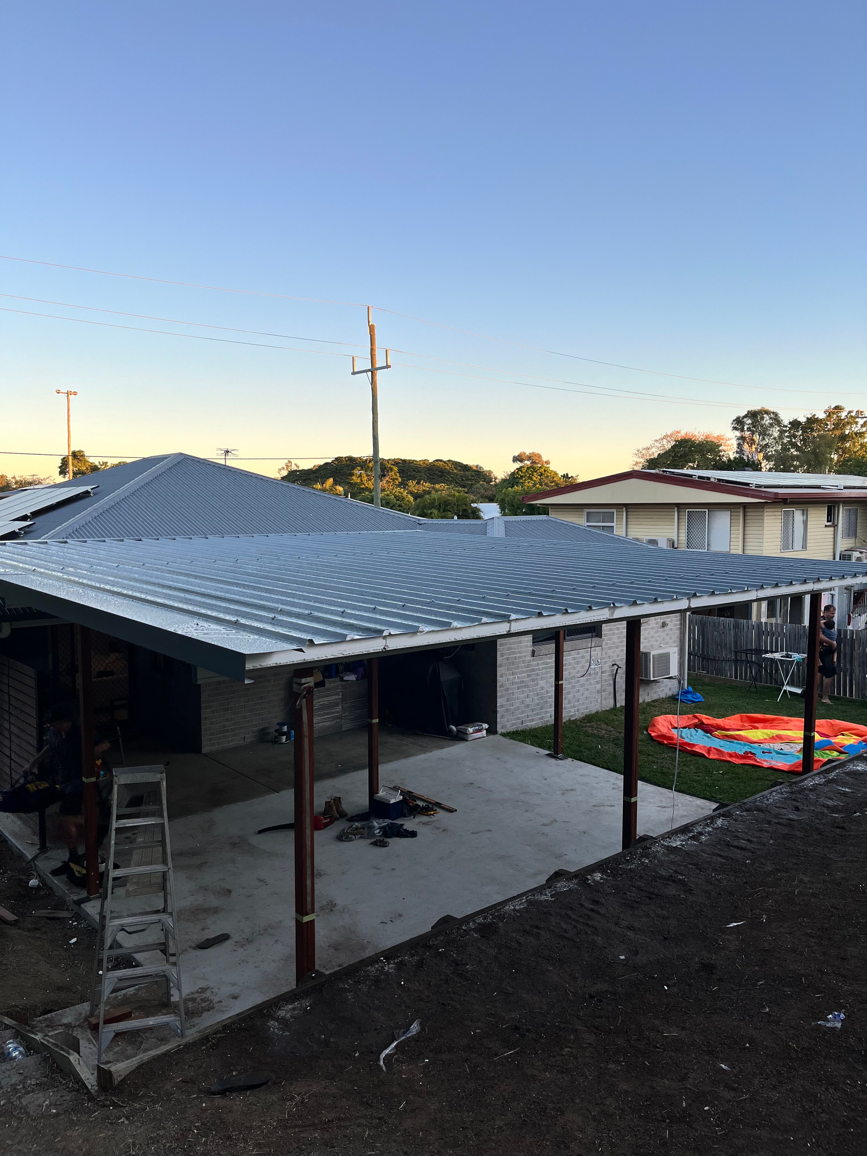 Completed carport and roof extension at sunset
